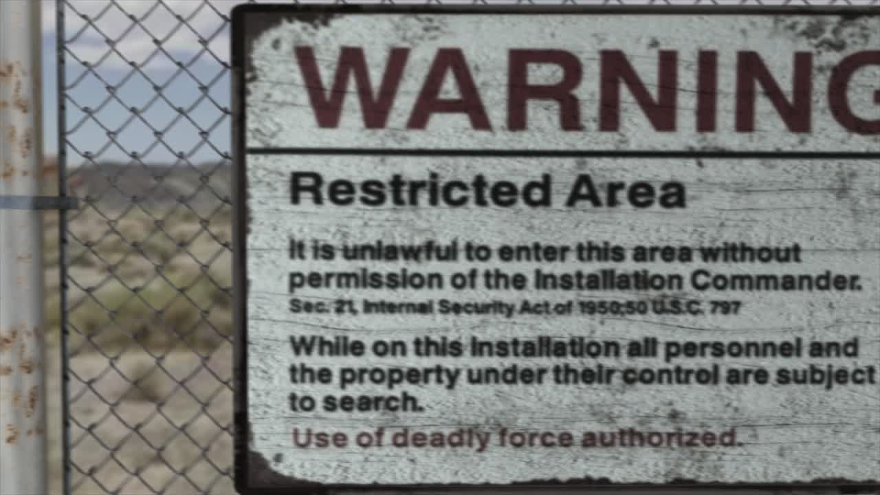 High quality 3D CGI render of a chainlink fence at a high security installation in a desert scene, with a Warning Restricted Area sign