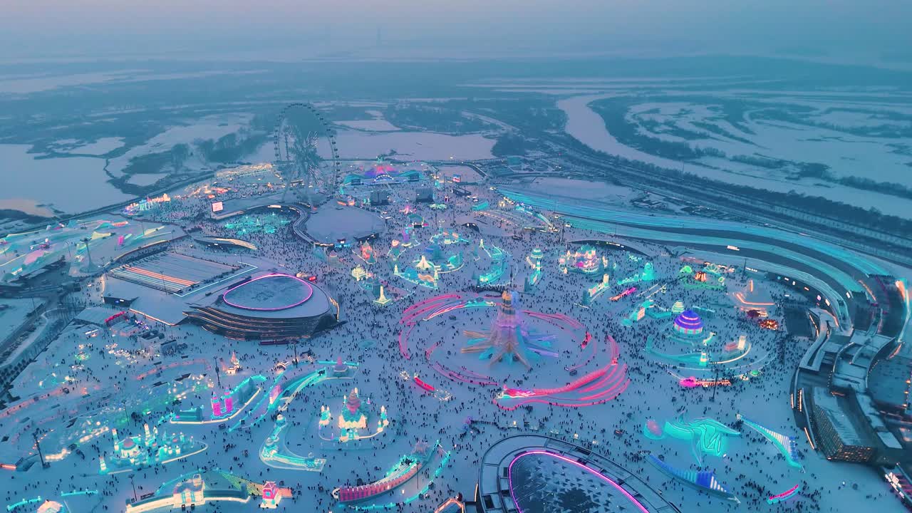 Pull out drone shot of Harbin Ice Festival at blue hour in Harbin, Heilongjiang, China