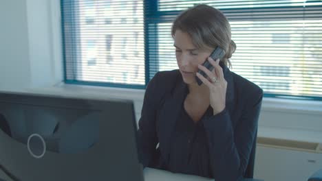 serious confident businesswoman talking on cell