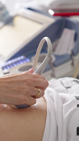 sonogram procedure to a pregnant woman. doctor does ultrasound in the hospital. ultrasound investigation of pregnant woman. pregnancy and healthcare concept. vertical video