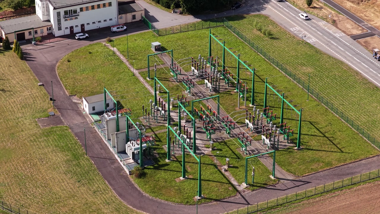 A high-voltage electrical switchboard switches and transforms electricity to the city from it. Drone view