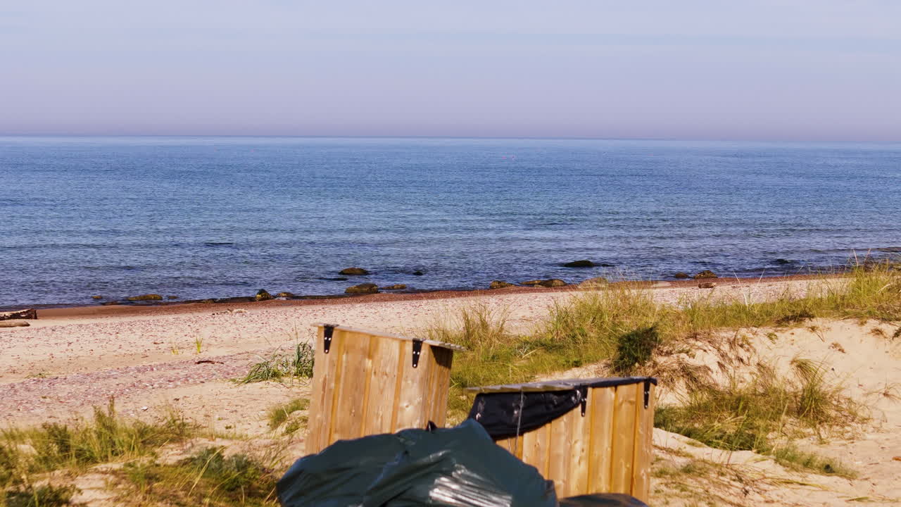 Peaceful Shores Of Uzavas ieteka With A Pile Of Garbage Bags In Latvia. Aerial Pullback Shot