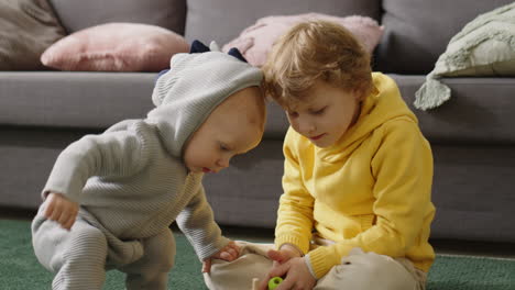 little kids playing stacking toy at home