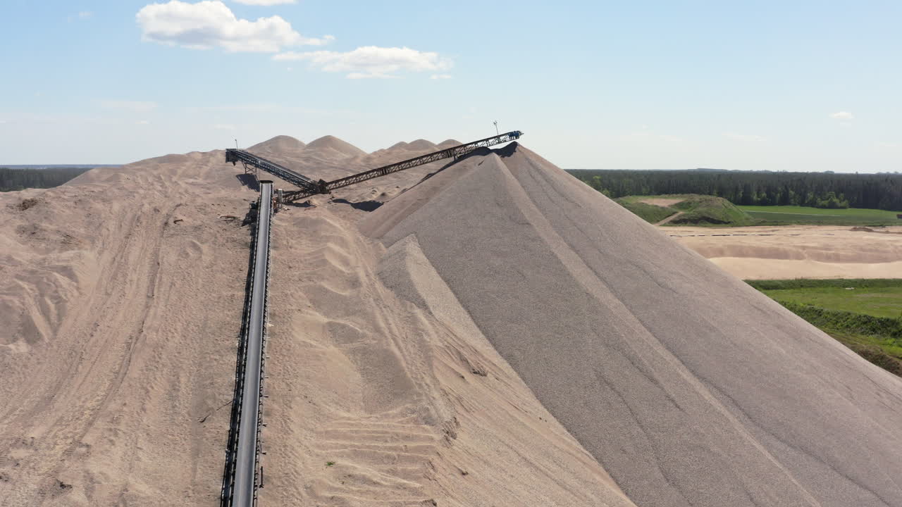 Pile Of Sand With Conveyor Belt System - Aggregate Extraction Quarry Site. - aerial shot