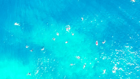 samar island, philippines - tourist enjoy swimming on the clear blue ocean during summer vacation - beautiful tourist destination - aerial shot