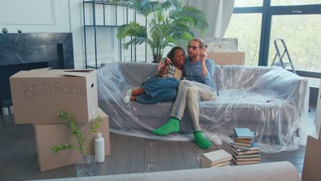 cozy moments on a sofa as a couple enjoys their new apartment in spring