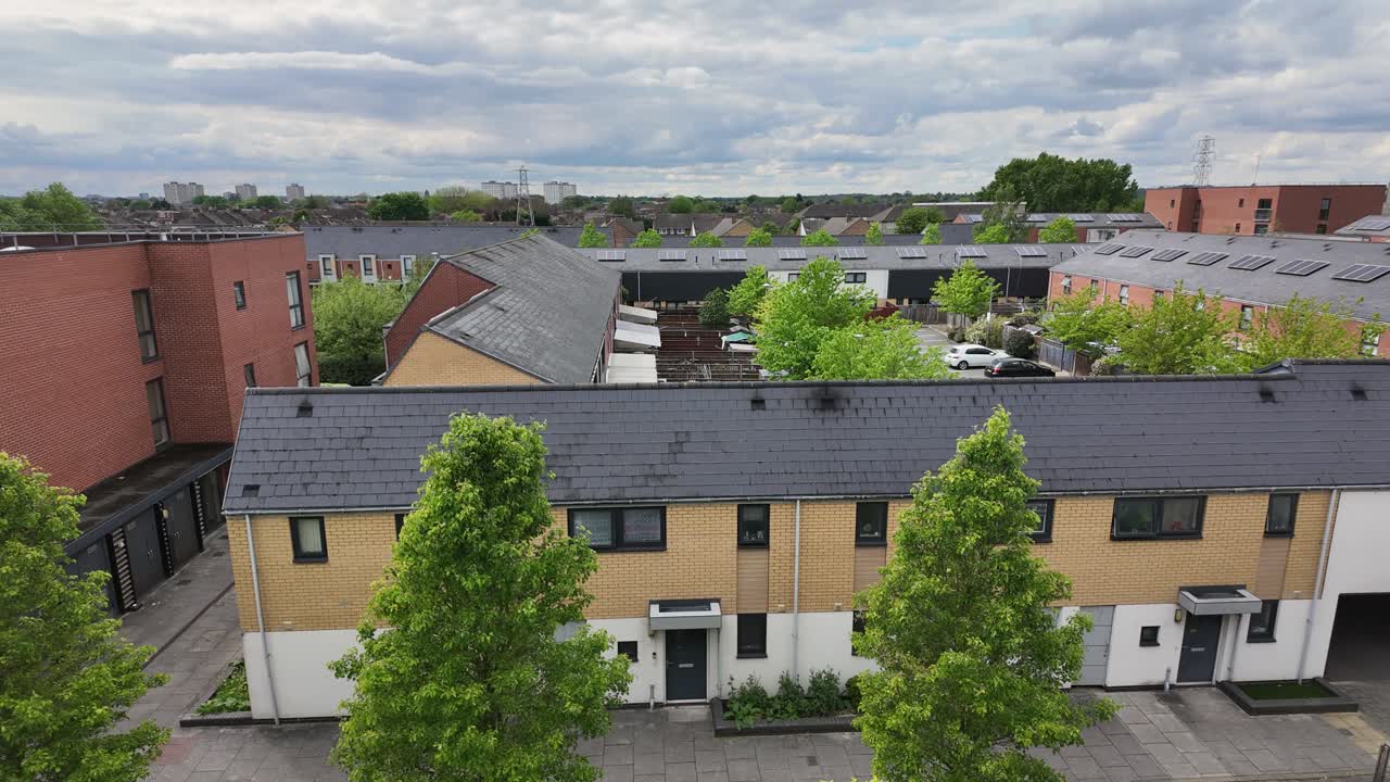 Skyline view of suburban area in London, featuring trees and rooftops in timelapse