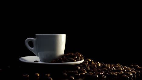 a cup of hot coffee on a black background