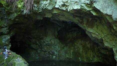 panning down on an entrance of a cave, a sacred place known as the site of the tomb of the egyptian goddess bastet, located in strandzha mountain in bulgaria