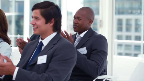 business audience applauding in rhythm
