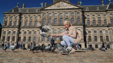 Woman-Is-Feeding-Pigeons-In-Dam-Square