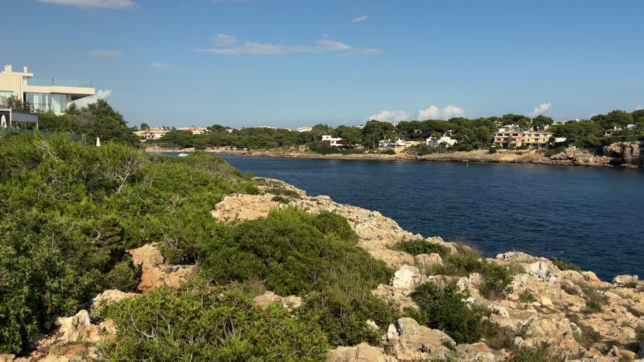 Scenic view of rocky coastline and seaside homes at Cala Sa Cova Foradada Mallorca