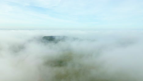 scene of foggy clouds covering over rural nature in early morning