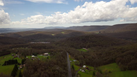 timelapse aéreo de drones de las montañas centrales de pennsylvania en la primavera con campos verdes, cielos azules y grandes nubes blancas