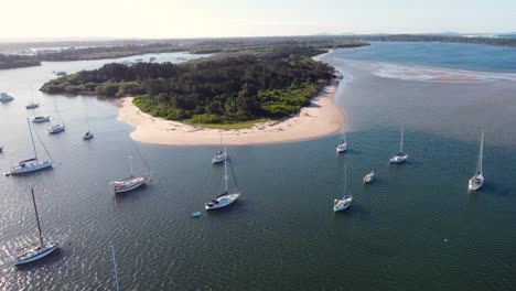 aerial drone shot of nature sand flat banks island in hastings river inlet with yachts and sail boats pacific ocean port macquarie nsw mid north coast australia 4k