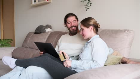 couple shopping online with cat