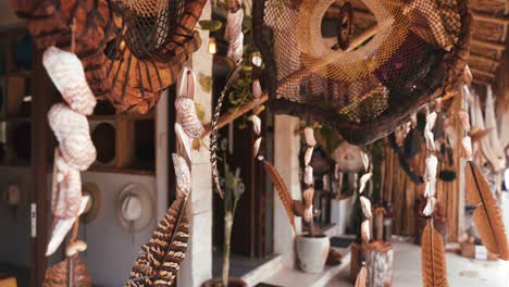 feathers amulet dream catcher with white feathers flying in wind sun.
