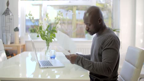 Worried-Man-Looking-at-Finances