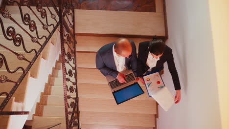 top view of businessman holding laptop discussing