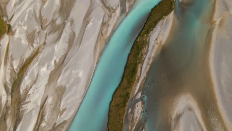 overhead fly-over of picturesque turquoise river delta in new zealand