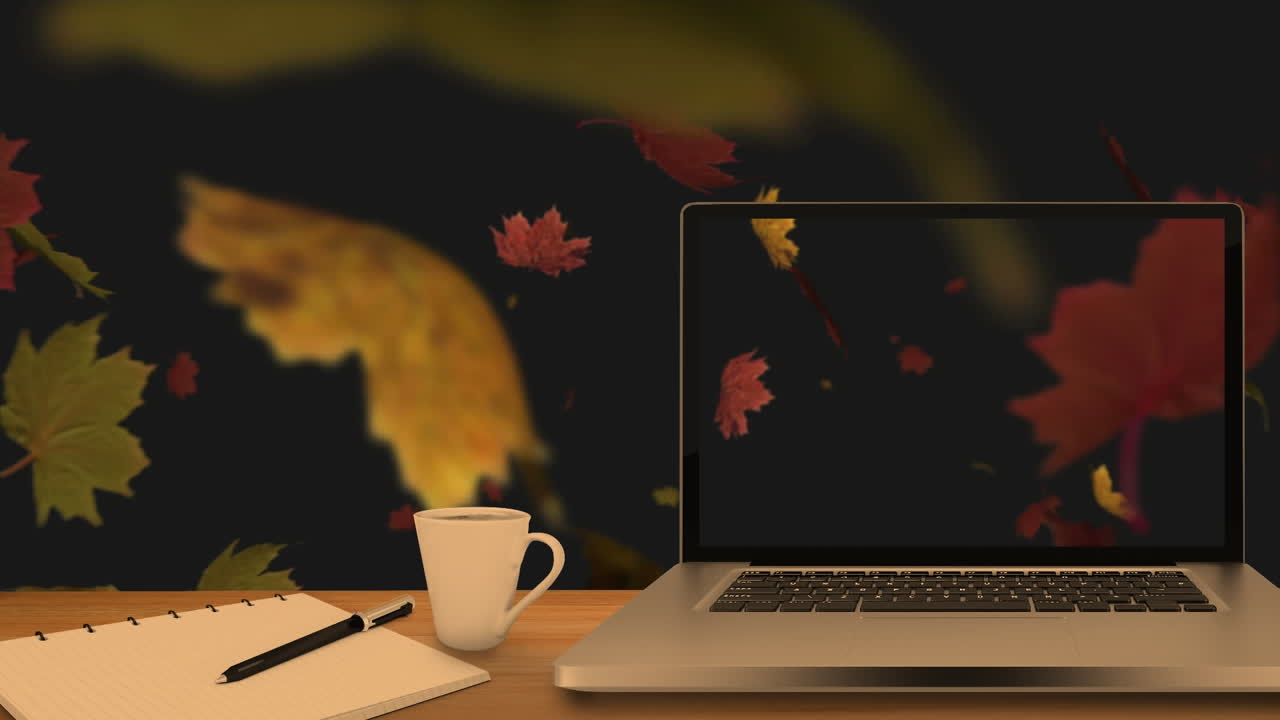 Desktop computer and office equipment on a table against autumn maples leaves floating in background