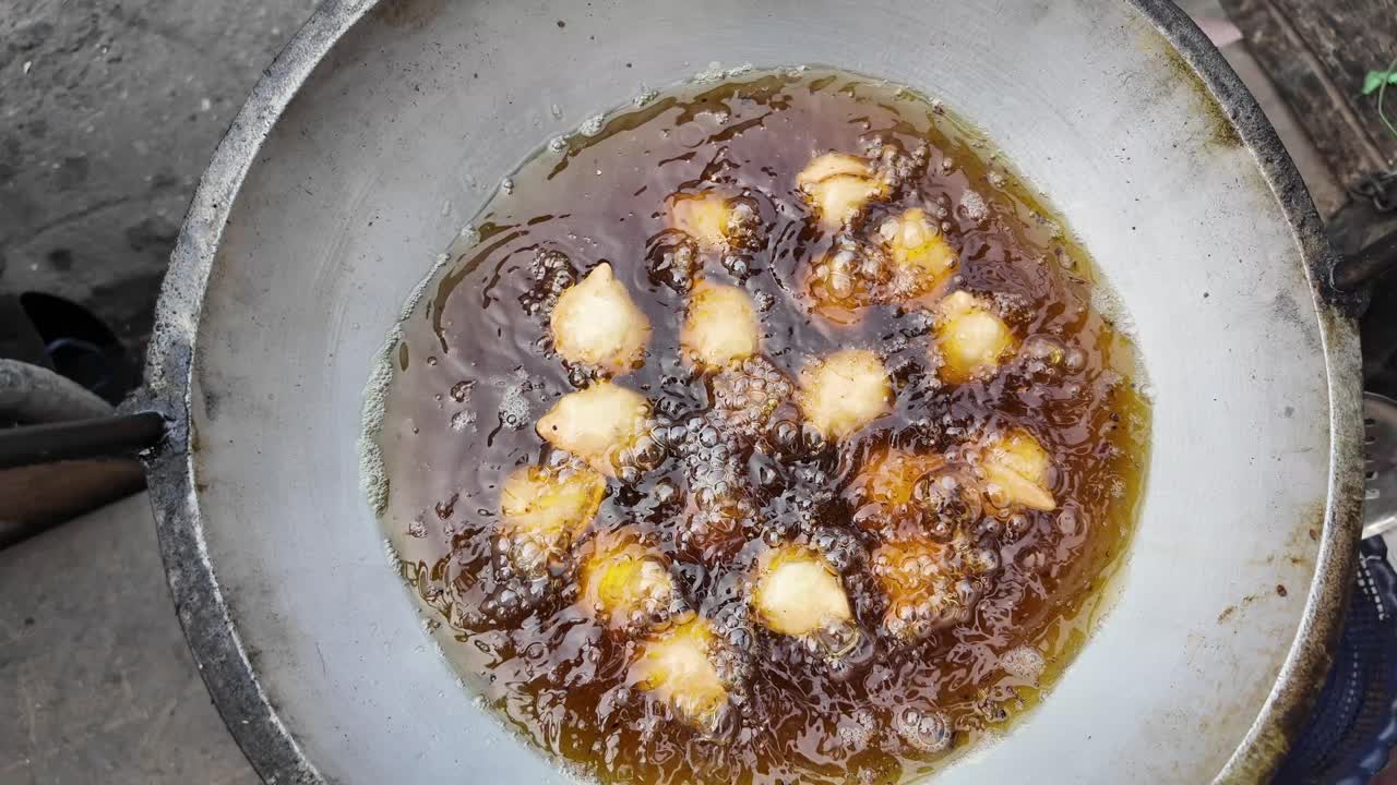 Pakoras frying in a pan