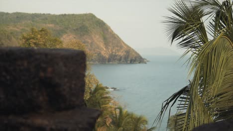 Slow-panning-shot-of-the-beautiful-Indian-coastline-through-a-hole-in-a-wall