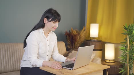 unhappy woman using laptop laptop at night. it's not in a good mood.