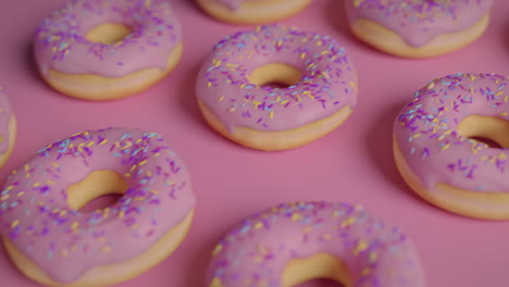 pink glaze donuts on a pink background