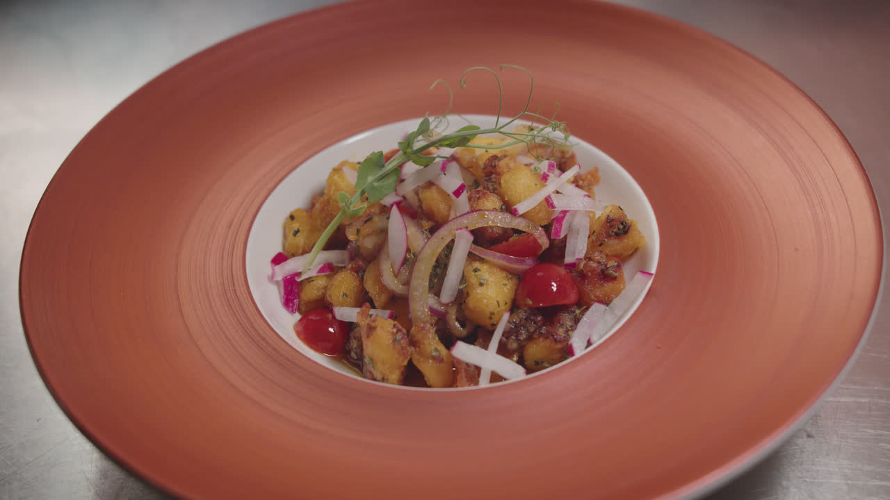Chef plating a delicious potato and vegetable salad