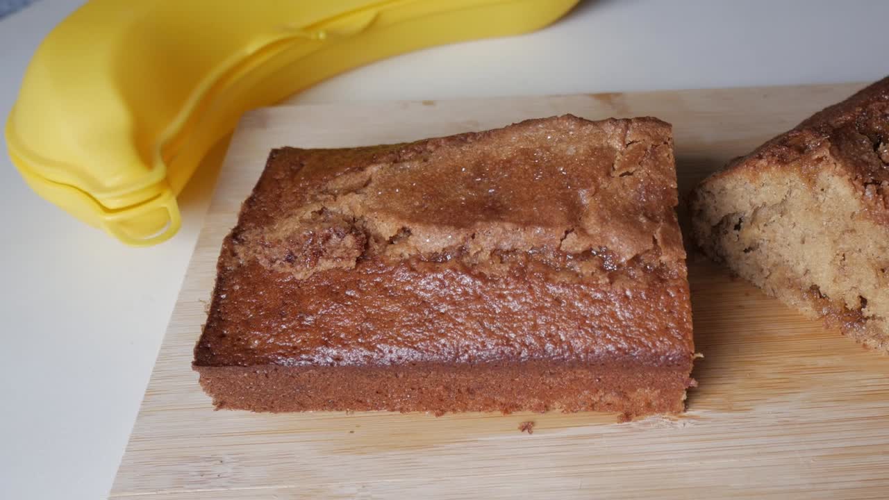 Fresh banana bread on wooden board, evokes warmth and homely comfort