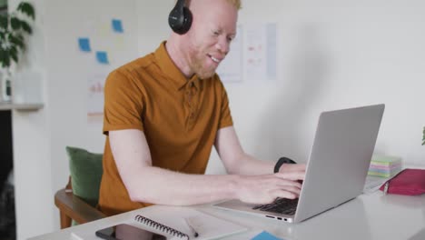 albino african american man with dreadlocks making video call on the laptop