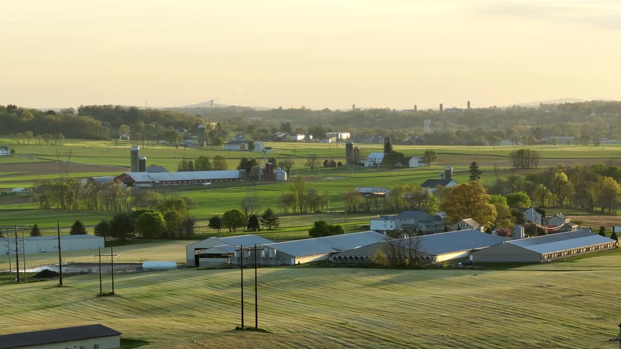 Panoramic View of a Rural Farm Landscape with Barns and Green Fields