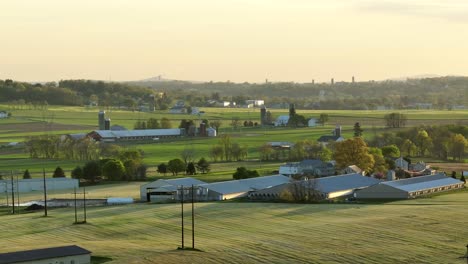 panoramic view of a rural farm landscape with barns and green fields