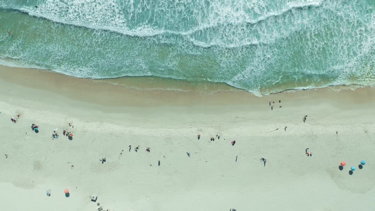 Aerial View of Crowded Beach with Turquoise Water and Waves