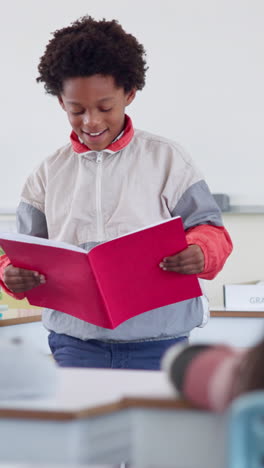young boy giving a presentation in a classroom