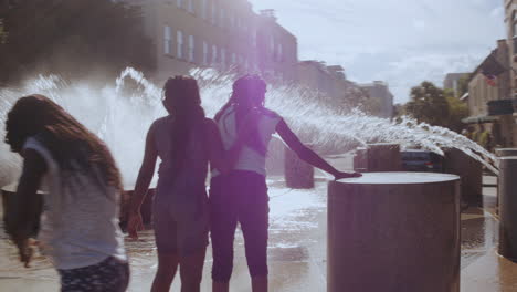 diverse kids playing at waterfront park fountain, day, moving