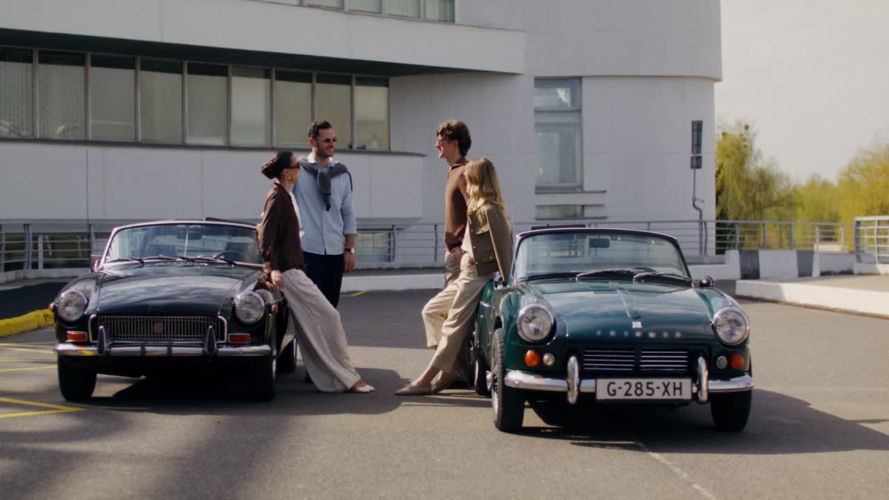 Friends Posing Beside Classic Cars