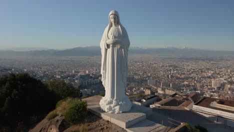grand virgin mary statue overlooking a city