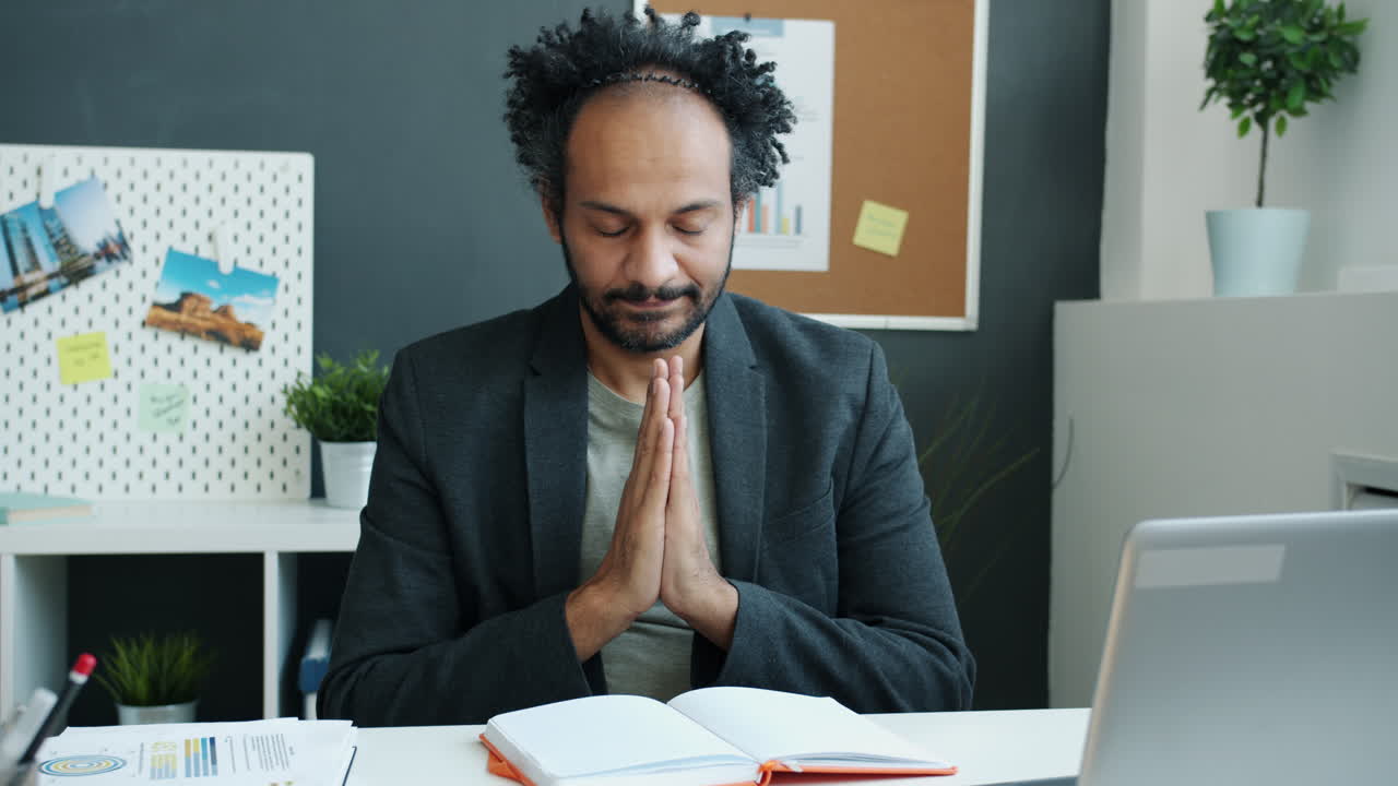 Man Meditating in Office