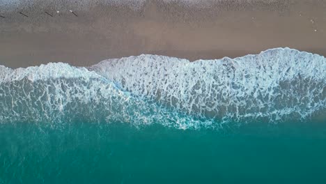 Beautiful-sea-waves-crushing-on-a-sandy-beach-in-the-mediterranean-sea-after-sunset