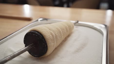 Chimney-cake-pastry-being-prepared---rolling-in-sugar