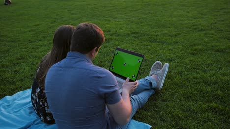 a happy couple using laptop