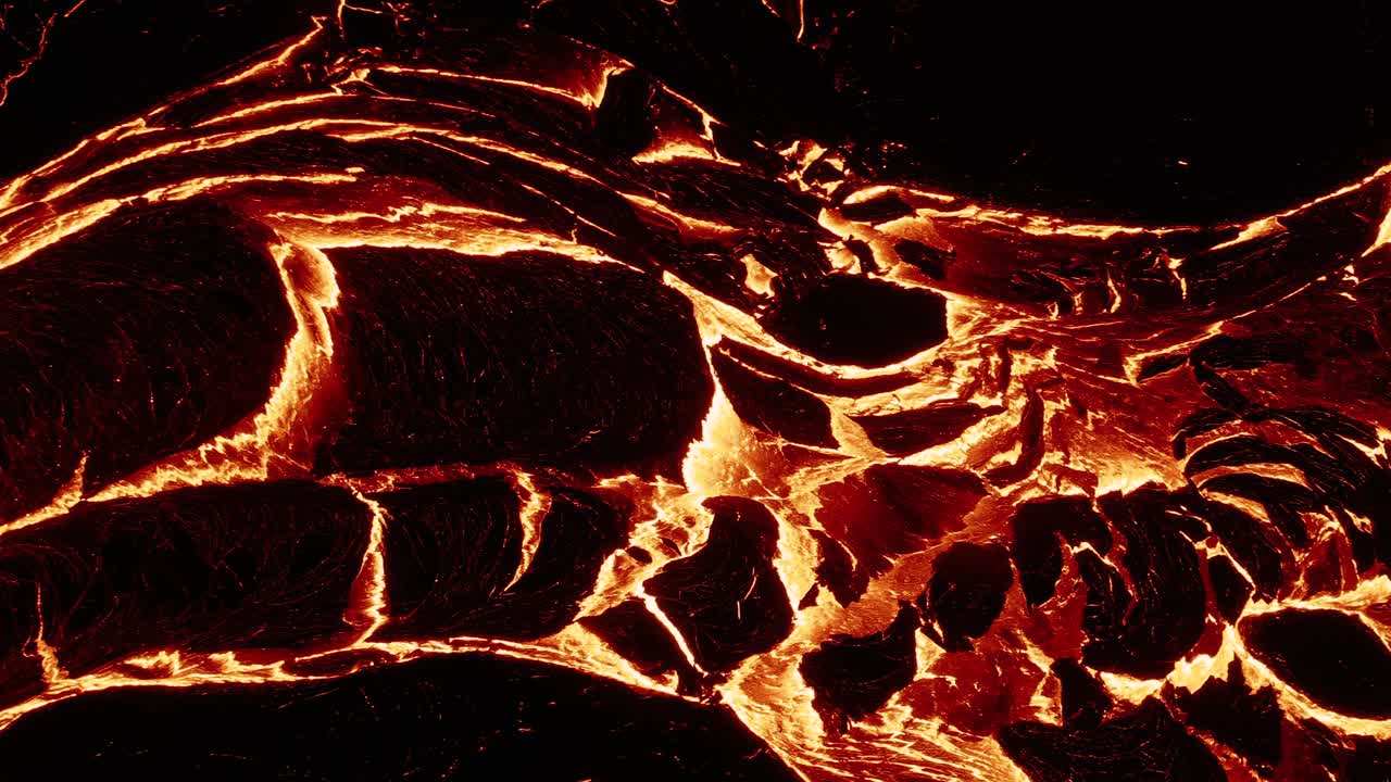 Oozing river of molten lava emitting extreme heat at night, igneous magma