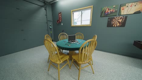 poker table set up in the game room garage of a large home