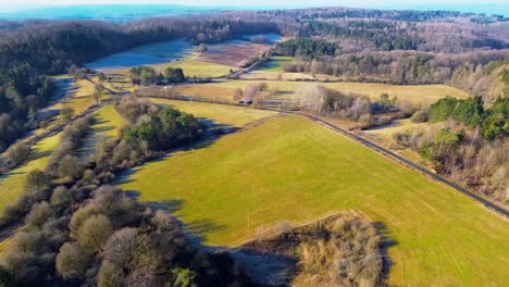 Aerial-Sweep-of-Sunlit-Fields-and-Woodlands-in-Serene-Countryside