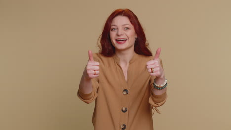 hipster woman raises thumbs up agrees or gives positive reply recommends advertisement likes good