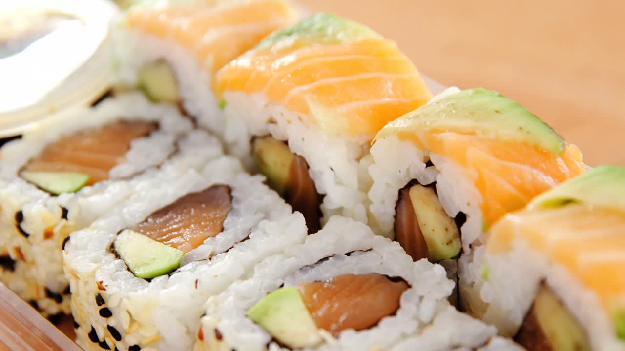 rollos de sushi con salmón en un recipiente de plástico