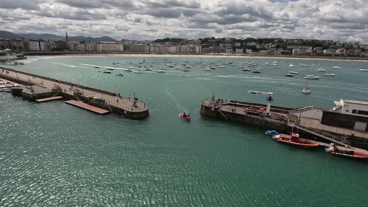 Boat enters San Sebastian marina from La Concha bay in northern Spain
