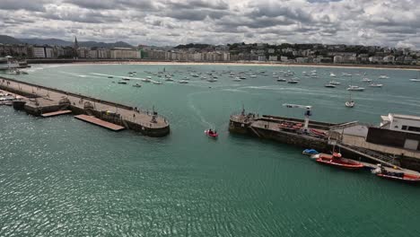 boat enters san sebastian marina from la concha bay in northern spain